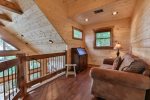 Open area in the loft offers a comfortable spot for reading 